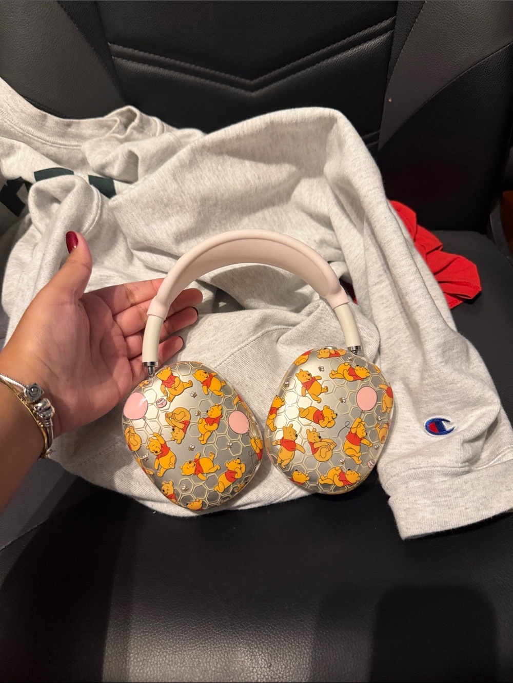 AirPod pro max with Winnie the Pooh cover and pink charging case and white cha